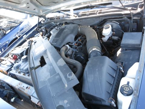2001 Ford Crown Victoria - The engine bay of a 2001 Ford Crown Victoria, showing the air intake system and brake fluid reservoir.