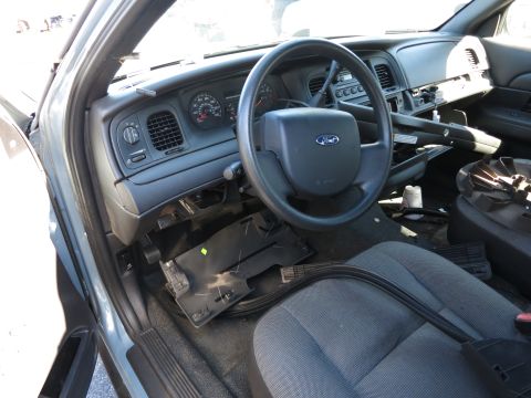 2001 Ford Crown Victoria - The interior of a 2001 Ford Crown Victoria is visible, with the dashboard and steering wheel in focus.
