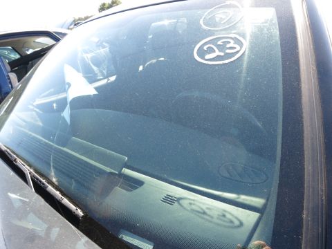 2001 Ford Crown Victoria - A view through the dusty windshield of a car, showing the dashboard and another vehicle in the background.