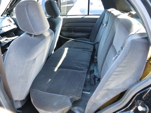 2001 Ford Crown Victoria - The rear interior of a 2001 Ford Crown Victoria, showing the bench seat and door panel.