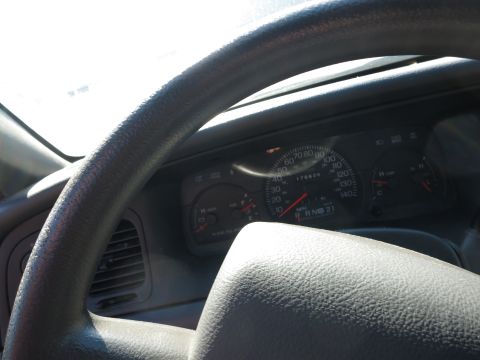 2001 Ford Crown Victoria - Interior view of a 2001 Ford Crown Victoria, displaying the dashboard and steering wheel.