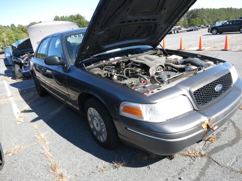 2001 Ford Crown Victoria - Dark gray 2001 Ford Crown Victoria, hood open, parked outdoors with another vehicle behind it.