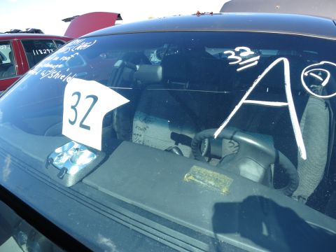 2001 Ford Crown Victoria - Interior view of a car in a junkyard with various markings on the windshield and dashboard.