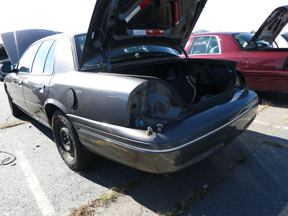 Gray 2001 Ford Crown Victoria, rear view, trunk open, missing taillights
