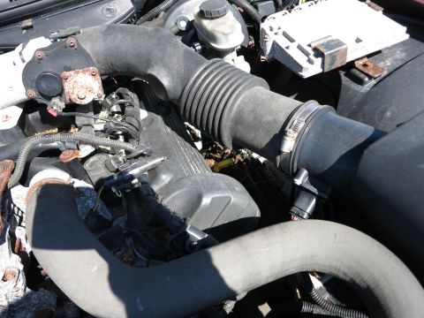 2001 Ford Crown Victoria - Close-up view of an engine bay, showing the air intake system and engine cover.