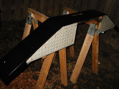 1985 Ford Bronco - Custom winch bumper with diamond plate accents, displayed on sawhorses.