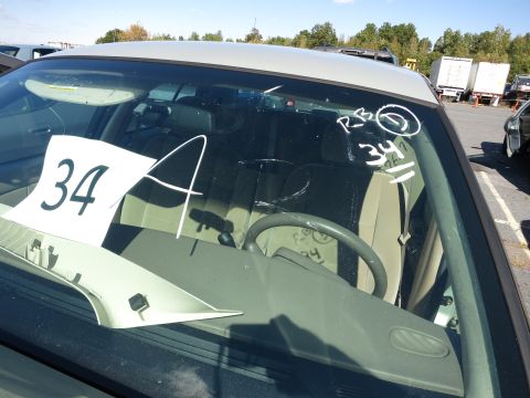 2001 Ford Crown Victoria - Interior view of a car with handwritten markings and a paper tag on the windshield.