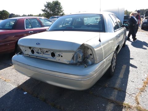 2001 Ford Crown Victoria - Rear view of a silver 2001 Ford Crown Victoria with damage to the rear bumper and missing taillights.