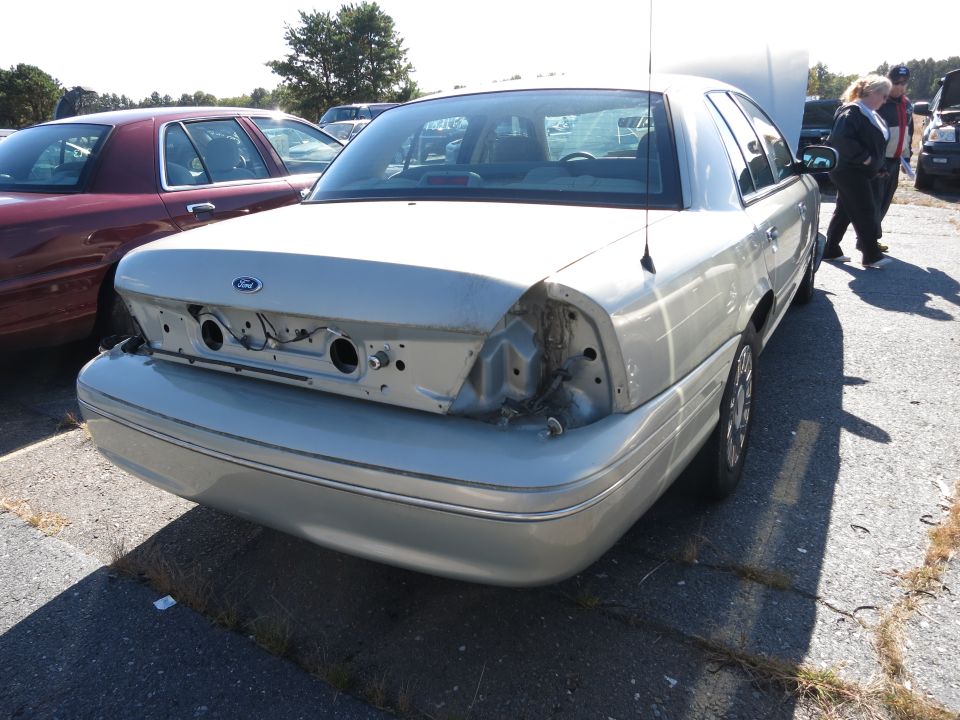 Silver 2001 Ford Crown Victoria, rear view, missing taillights and bumper cover