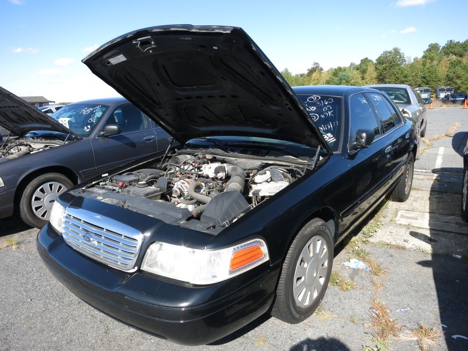 Black 2001 Ford Crown Victoria with hood open, showing engine. Front 3/4 view
