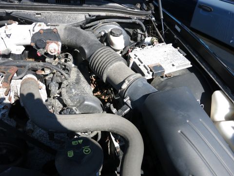 2001 Ford Crown Victoria - Close-up view of the engine compartment, showing various mechanical and electrical parts.