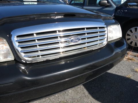 2001 Ford Crown Victoria - Close-up of the front grille and headlight assembly on a 2001 Ford Crown Victoria.