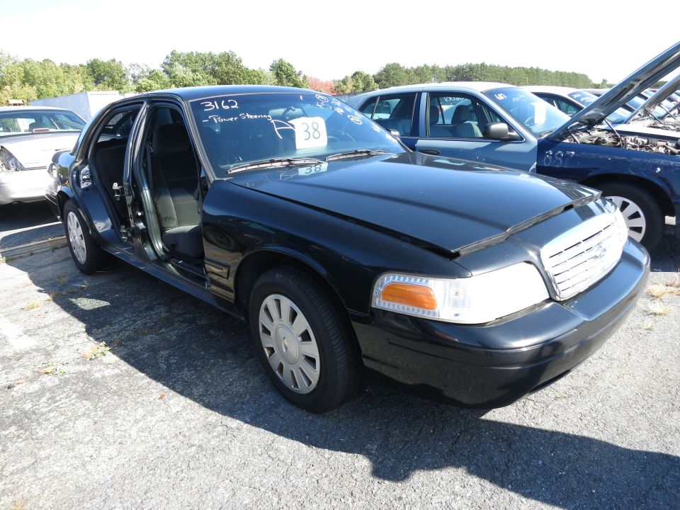 Black 2001 Ford Crown Victoria with driver's door open, front quarter view
