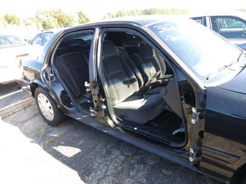 2001 Ford Crown Victoria - The interior of a black 2001 Ford Crown Victoria is visible with both passenger doors removed.
