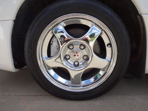 1995 Mitsubishi 3000GT - Chrome wheel and brake caliper with Mitsubishi branding visible.