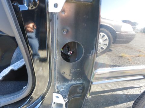 2001 Ford Crown Victoria - The reflection in the car door shows another vehicle, possibly a police car, in the background.