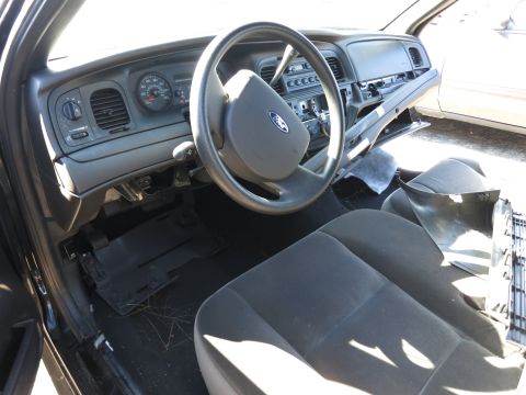 2001 Ford Crown Victoria - The interior of a 2001 Ford Crown Victoria, the dashboard, steering wheel, and seats.