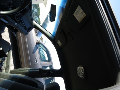 2001 Ford Crown Victoria - View from inside a car, looking out the passenger side window at another vehicle parked nearby.