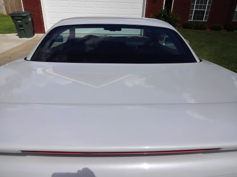 1995 Mitsubishi 3000GT - Rear view of a white 1995 Mitsubishi 3000GT with a red accent light bar.