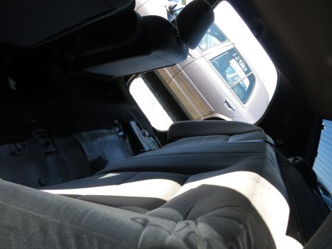 2001 Ford Crown Victoria - View from the interior of a car, showing the back seats and a glimpse of another vehicle outside.