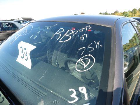 2001 Ford Crown Victoria - White markings on the windshield of a dark gray sedan obscure any year-identifying features.