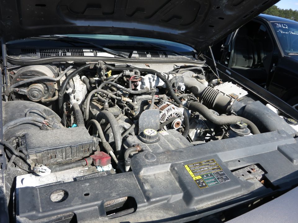 2001 Ford Crown Victoria engine bay with visible VIN plate and maintenance sticker
