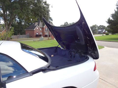 1995 Mitsubishi 3000GT - Rear trunk of a 1995 Mitsubishi 3000GT is open, revealing the storage compartment.