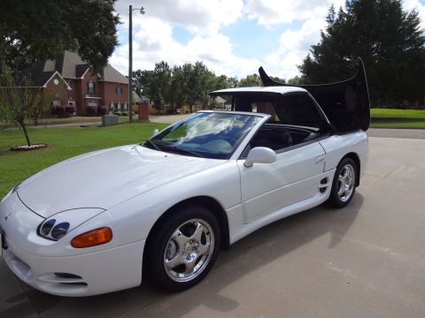 1995 Mitsubishi 3000GT - A white 1995 Mitsubishi 3000GT convertible is shown from a three-quarter front angle with its top and hood open.