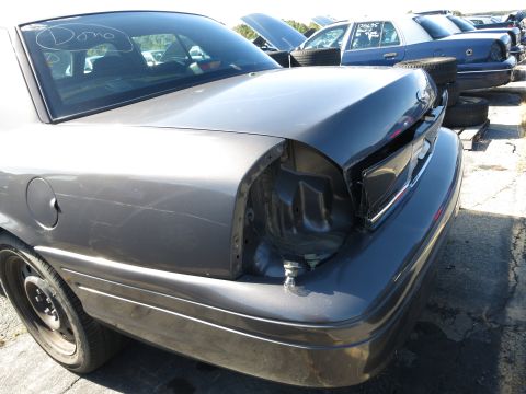 2001 Ford Crown Victoria - This 2001 Ford Crown Victoria is in a junkyard, showing its rear end with a missing taillight assembly.