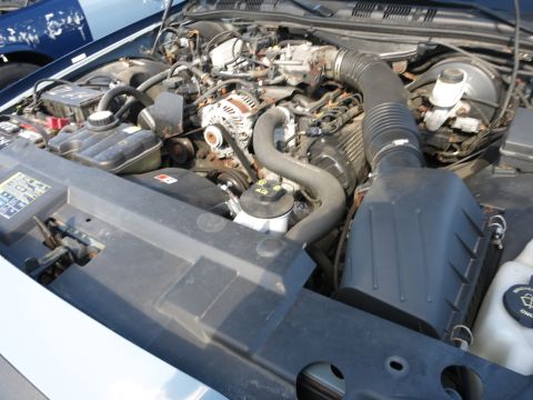 2001 Ford Crown Victoria - The engine compartment of a vehicle is shown, with various mechanical components visible.