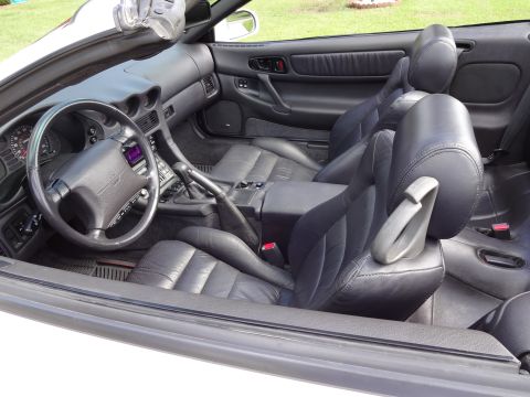 1995 Mitsubishi 3000GT - The interior of a Mitsubishi 3000GT features black leather seats and a detailed dashboard.