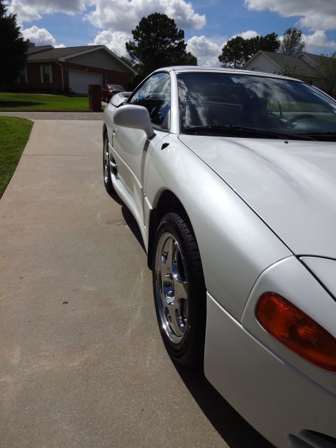 1995 Mitsubishi 3000GT - A white 1995 Mitsubishi 3000GT is shown from the front quarter angle on a sunny day.