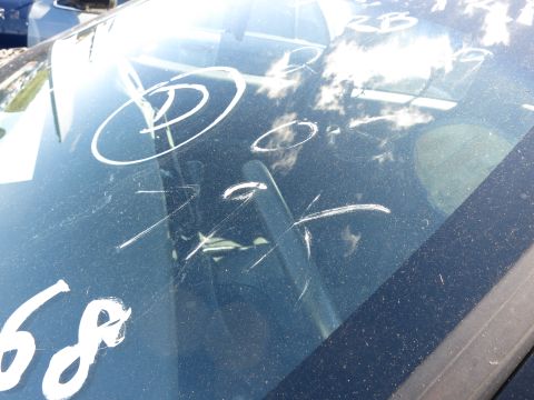 2001 Ford Crown Victoria - Windshield with white chalk markings and scratches.