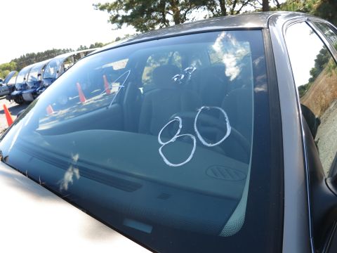 2001 Ford Crown Victoria - View through the windshield of a car's interior, with other vehicles in the background.