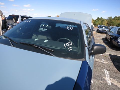 2001 Ford Crown Victoria - This car is in a lot with other vehicles, and has markings on the windshield.
