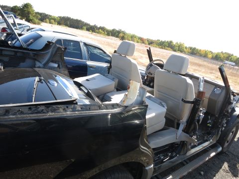 2001 Ford Crown Victoria - Wrecked car interior with exposed metal and a second vehicle visible in the background.
