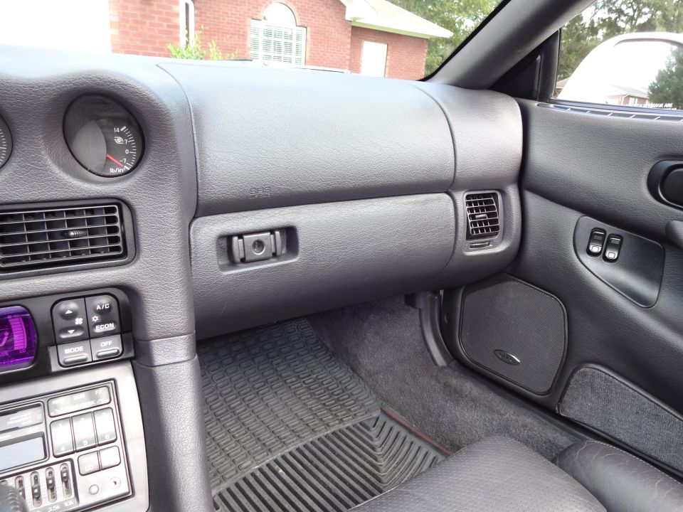 1995 Mitsubishi 3000GT interior showing dashboard, air vents, climate controls, and door panel with window switches