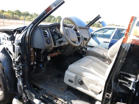 2001 Ford Crown Victoria - The interior of a damaged vehicle is shown, with a second vehicle visible behind it.