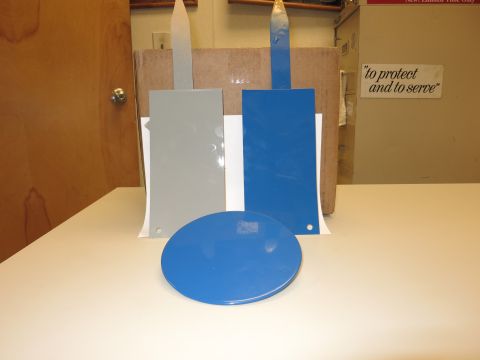 1991 Ford LTD Crown Victoria - Paint swatches are displayed on a table, with a sign reading "to protect and to serve" in the background.