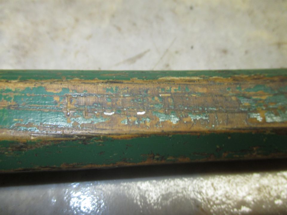 Worn green painted wood with peeling paint and visible wood grain