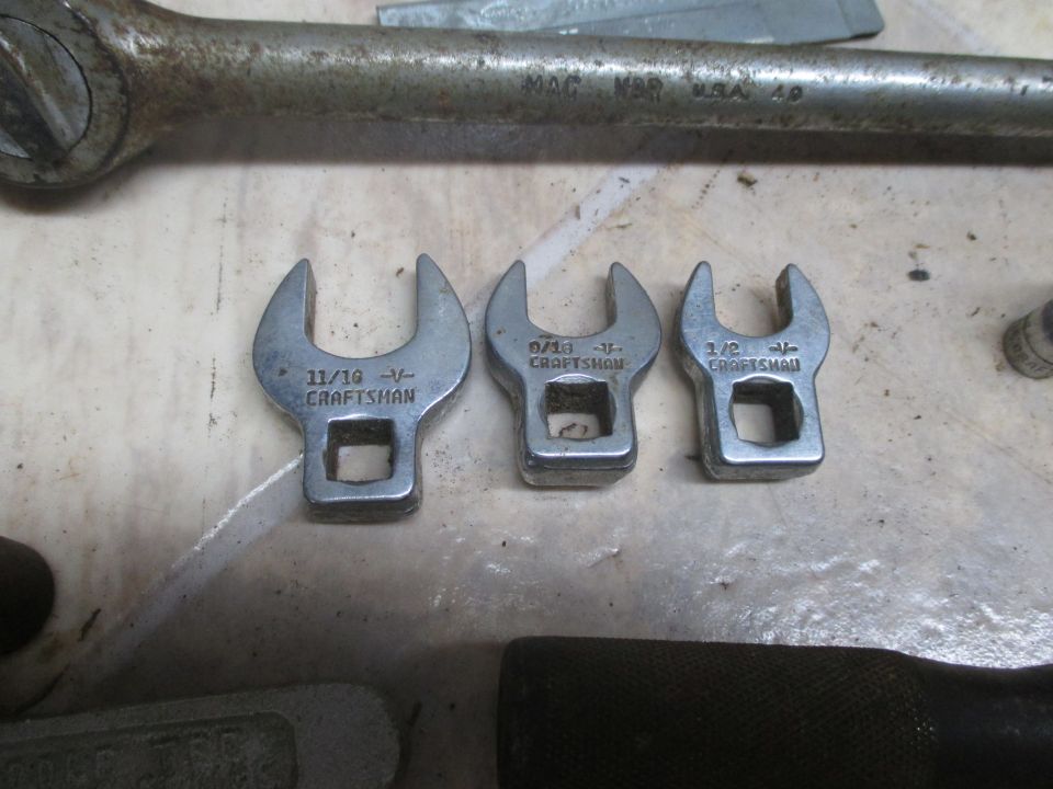 Three Craftsman wrenches and a MAC tools ratchet on a surface