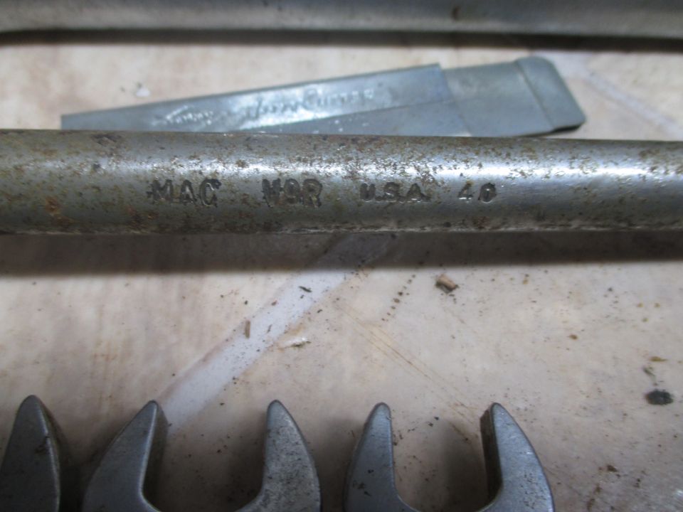 MAC N9R USA 40 stamped on a metal tool handle, with several wrench heads visible below