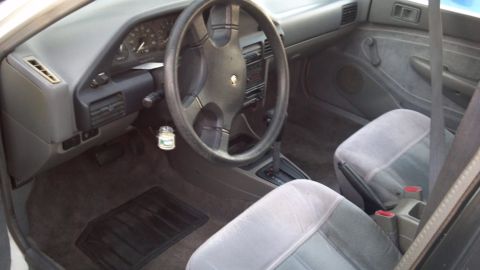 1993 Mercury Tracer - Interior view of a 1993 Mercury Tracer, showing the dashboard, steering wheel, and front seats.