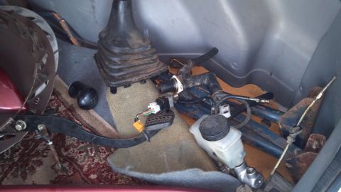 1993 Mercury Tracer - Various automotive parts are stored loosely in the cargo area of a vehicle.