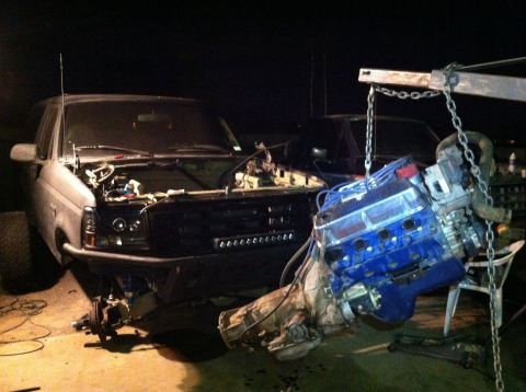 1995 Ford Bronco - A 1995 Ford Bronco is shown with its engine being hoisted out for repair or replacement.