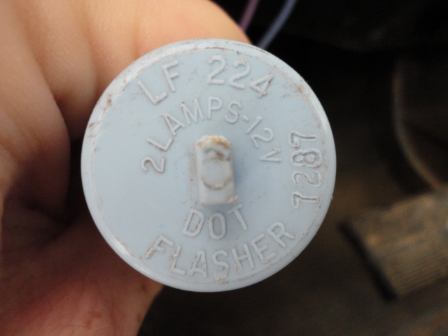 Blue LF 224 two-lamp 12V DOT flasher relay held in a hand, showing embossed markings