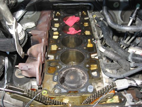 1994 Ford Bronco - Engine block with exposed cylinders and exhaust manifolds, showing signs of repair work or repair.