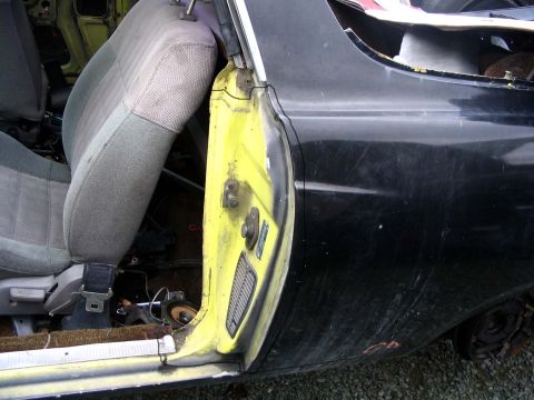 1971 Ford Ranchero - Interior view of a vehicle's yellow door jamb and grey fabric seat.