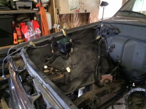1988 Suzuki Samurai - Engine bay of a vehicle showing wiring harness and fuse box, appears to be undergoing work.