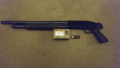 2000 Mercury Grand Marquis - Shotgun with ammunition box and shell on carpeted surface.